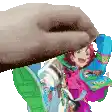 a hand is holding a picture of a cartoon character .