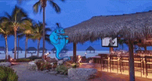 a blue genie is standing in front of a beach bar