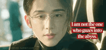 a close up of a man wearing glasses with the words i am not the one who gazes into the abyss below him