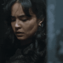 a close up of a woman 's face with a serious look on her face