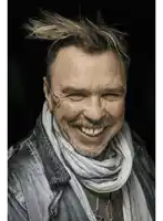 a man with a scarf around his neck and a necklace that says ' salomon ' on it