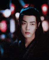 a close up of a young man 's face with a blurry background