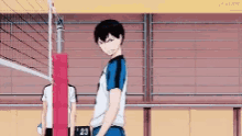 a man is standing in front of a volleyball net in a volleyball court .