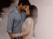 a man and a woman are standing next to each other in a foggy room