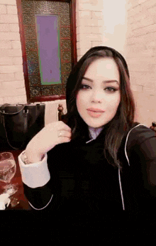 a woman taking a selfie with a stained glass window in the background