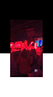 a man in a red shirt is standing in a crowd of people