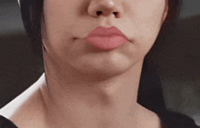 a close up of a woman 's face with a red lip