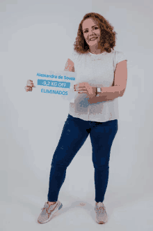 a woman holds a sign that says alessandra de souza