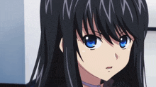 a close up of a girl 's face with blue eyes and black hair