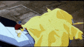 a man in a red shirt is holding a yellow cloth
