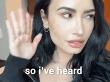 a woman is waving her hand and the words so i 've heard are behind her