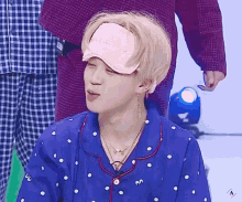 a person wearing a blue shirt and a pink hat