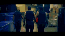 a group of wrestlers are standing next to each other in a room .
