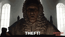 a man in a wig is saying theft in front of a window
