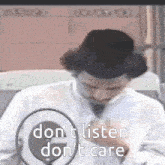 a man speaking into a microphone with the words do n't listen do n't care