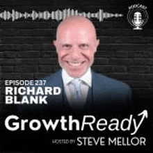 a man in a suit and tie is smiling in front of a brick wall on the cover of a podcast .