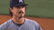 a man wearing a hat with the letter m on it