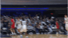 a blurry picture of a basketball game with a player wearing number 22
