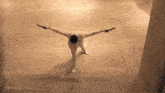 a man with his arms outstretched is in a movie clip