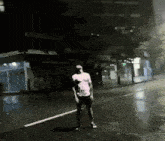 a man in a white shirt stands on the side of the road
