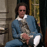 a man in a blue jacket and white socks adjusts his shoe
