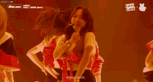 a group of girls are dancing on a stage and the words lulu lala are on the screen