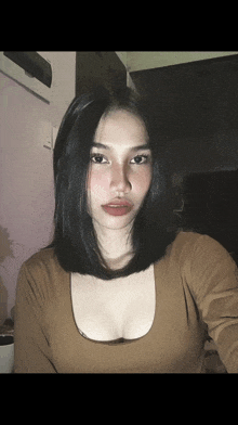 a woman taking a picture of herself with a plunging neckline