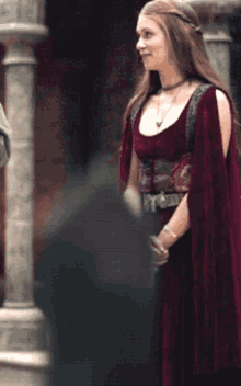 a woman in a red dress with a purple belt