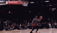 a man is dunking a basketball in front of a crowd at the nba all star 2018
