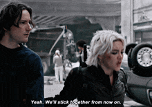 a man and a woman are standing next to each other and the man says yeah we 'll stick together from now on