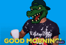 a man wearing a rolling stones shirt holds a cup of coffee