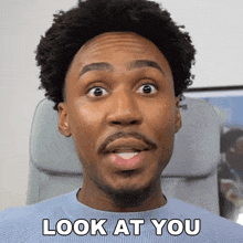 a man with a surprised look on his face and the words look at you above him