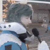 a person in a costume is talking into a microphone while wearing a helmet .