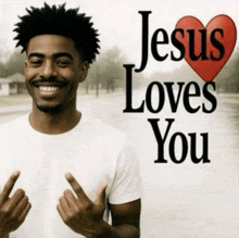a man is smiling in front of a poster that says jesus loves you