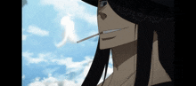a man with long black hair is smoking a cigarette in front of a blue sky