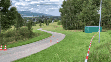 a green container sits on the side of the road