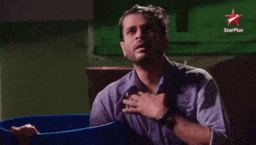 a man is crying in front of a star plus sign