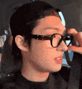 a close up of a person wearing glasses and a hat .