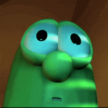 a close up of a green cartoon character 's face with big eyes