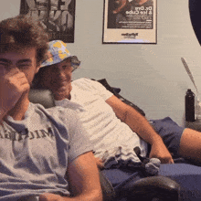 two men are sitting in front of a poster that says ice caps on it