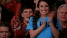 a woman wearing a blue shirt that says " team finn "