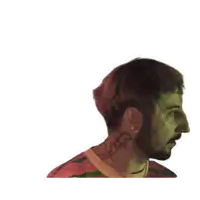 a man with a beard wearing a striped shirt