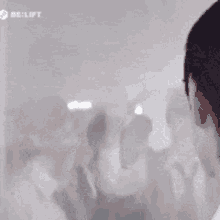 a group of people are standing in a room behind a glass .