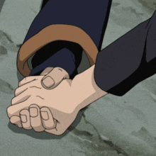 a person holding another person 's hand with a fist