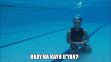 a man giving a thumbs up in a swimming pool with the caption okay ba kayo d'yan