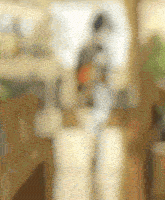 a blurry picture of a person standing in front of a table