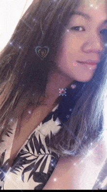 a woman in a white and black dress with a heart shaped earring