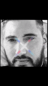 a close up of a man 's face with an x in the middle of his eye