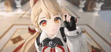 a girl with long blonde hair and red eyes is wearing a white shirt and gloves .