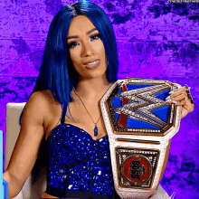 a woman with blue hair holds a wrestling championship belt
